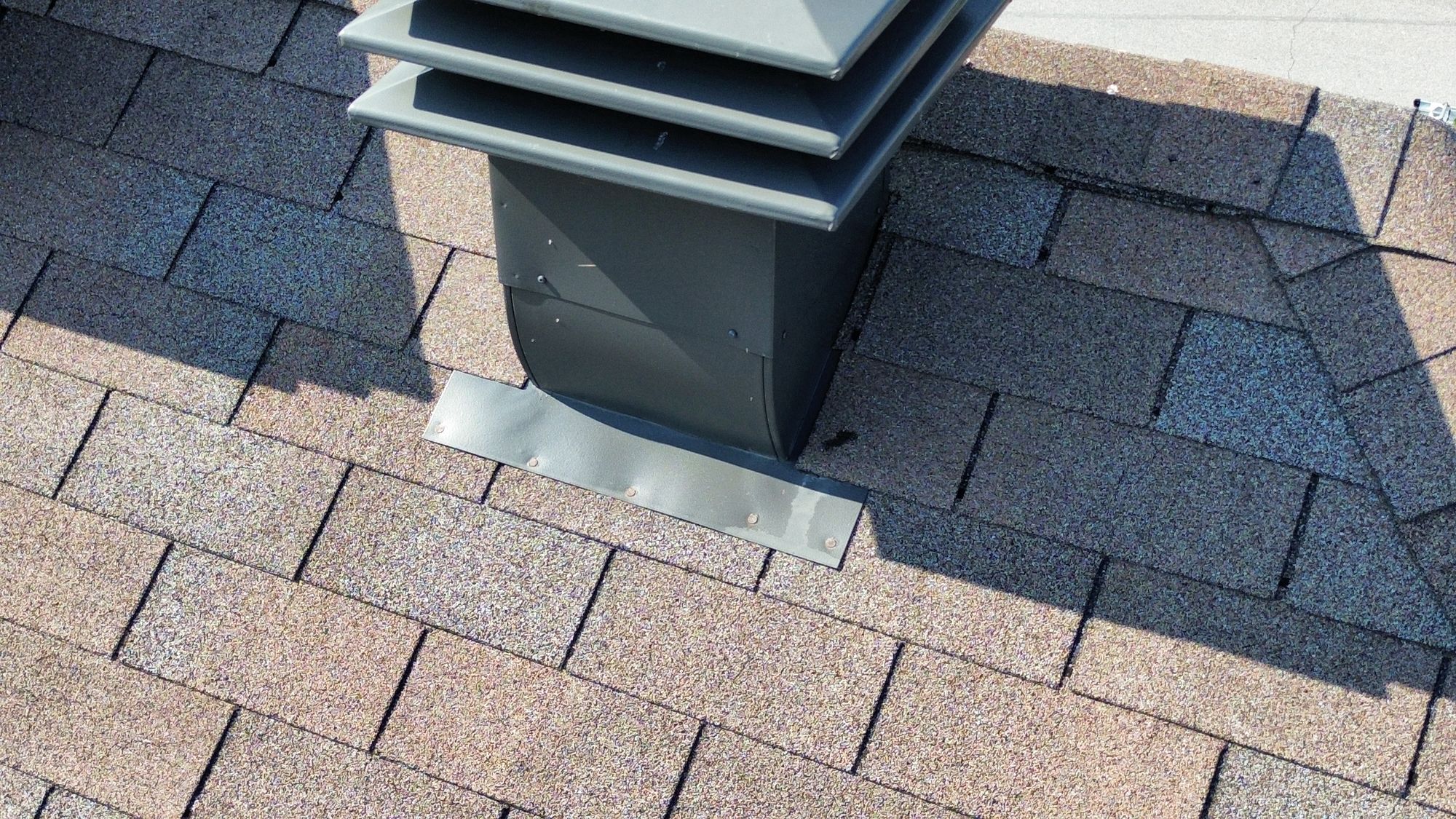 Close-up drone photo of exposed fasteners on a roof vent flashing plate found during a Nepean home inspection