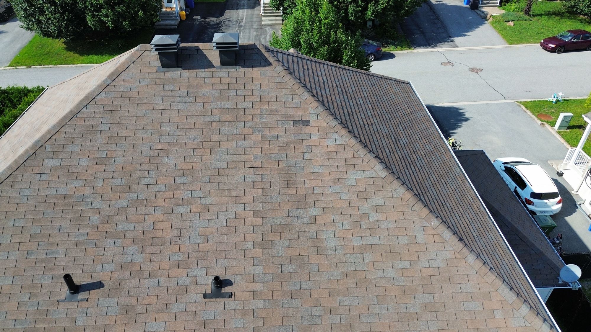 Previous shingle repair, missing shingle, and shingle lifting found during a Nepean home inspection