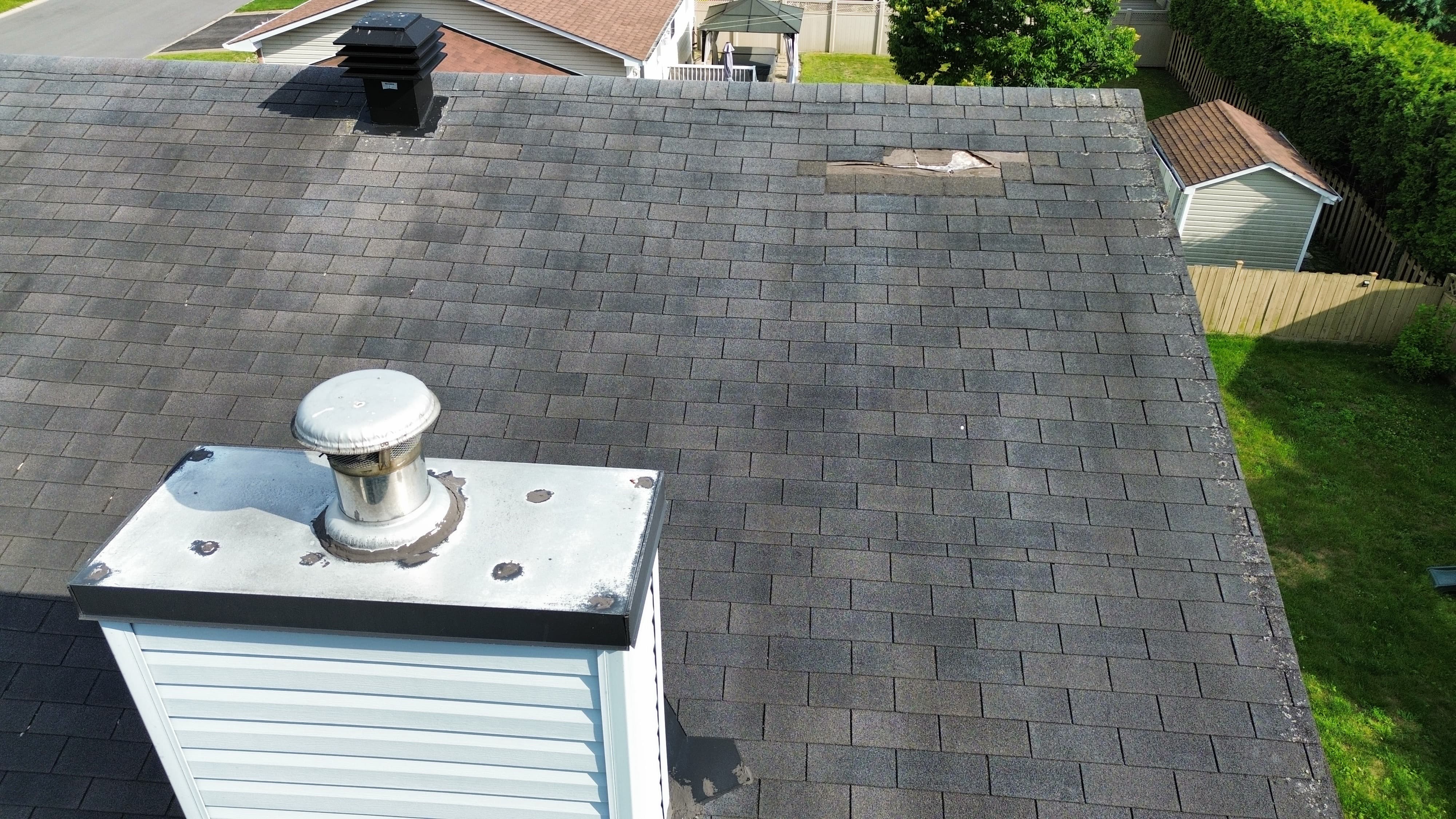 Drone photo of roof vent flashing near a missing shingle patch with visible granular loss, home inspection in Orléans, Ottawa