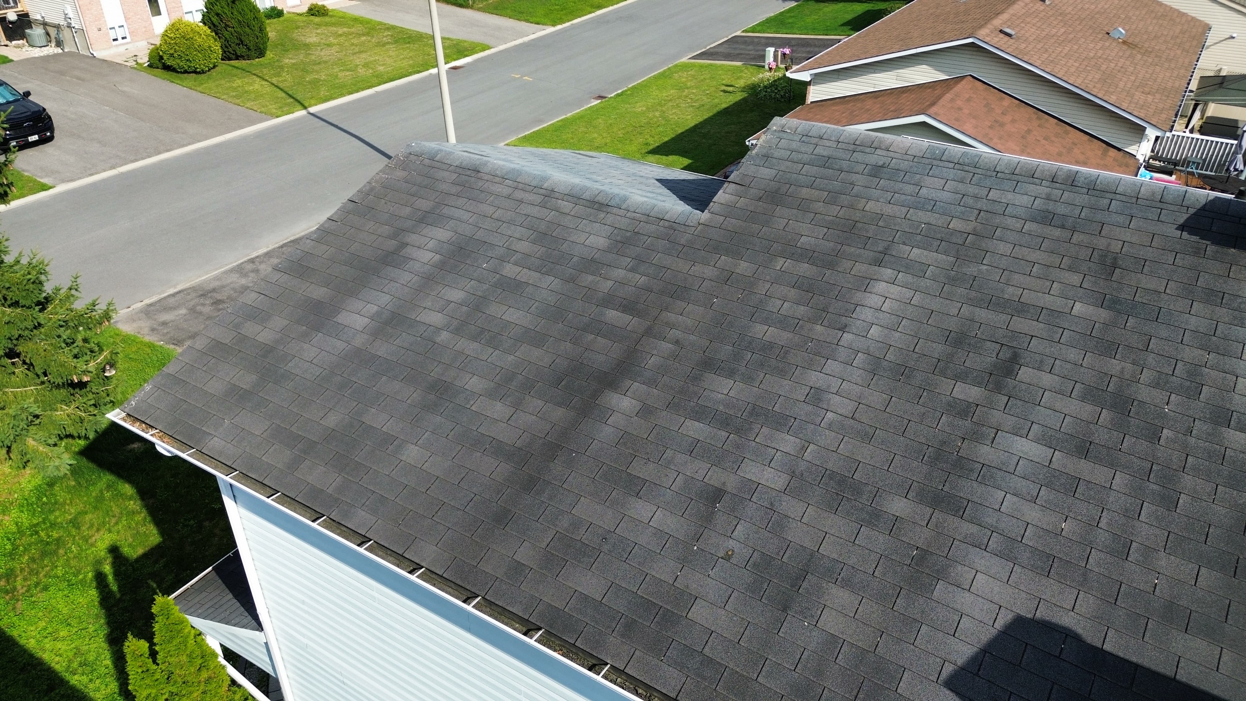 Aerial drone photo of a roof ridge showing a wavy roofline consistent with sagging sheathing, home inspection in Orléans, Ottawa